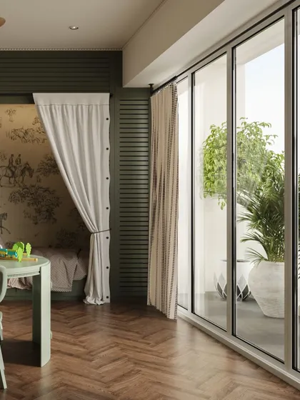 A view from the play area towards the balcony, showing how the room is filled with natural light. The herringbone wood flooring and sage green furniture create a stylish yet child-friendly space.