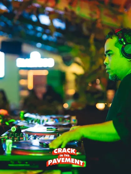 Another angle from the 'Crack in the Pavement' hip-hop event, with the green light setting the mood as I work the turntables.