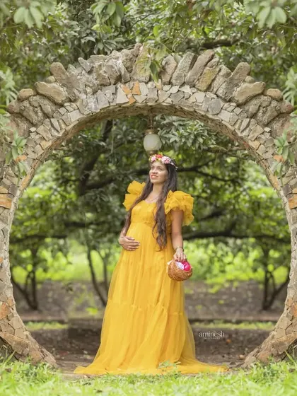 Taking your maternity session outdoors adds a beautiful, natural element. I found this stunning stone archway for a shoot, using the golden hour light to complement this vibrant yellow gown.