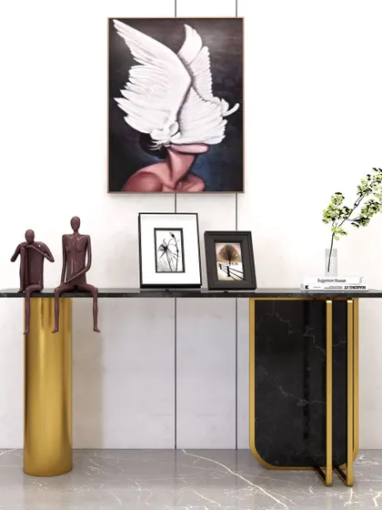 An asymmetrical console table that blends black marble with a cylindrical gold leg, creating a bold and artistic piece of furniture.