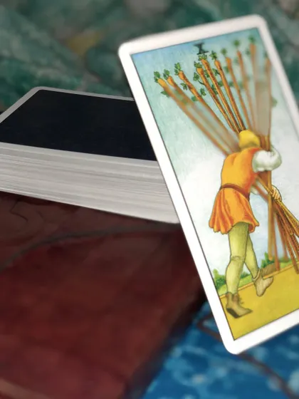 The Ten of Wands signifies carrying a heavy burden. If this card appears, it's a message from the universe that you need to reassess your priorities and not be afraid to ask for help. You don't have to carry it all alone.