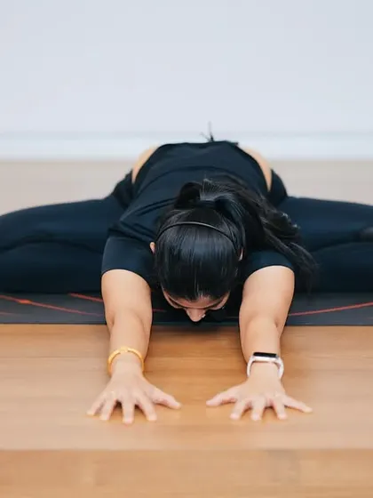 A deep forward fold like this helps release tension in the back and shoulders, a common issue for those who sit at a desk all day. My sessions focus on such restorative poses for immediate relief.