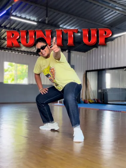 The "Run It Up" challenge is on. This pose captures the playful and confident energy of our street dance classes, where students learn to express themselves fully.