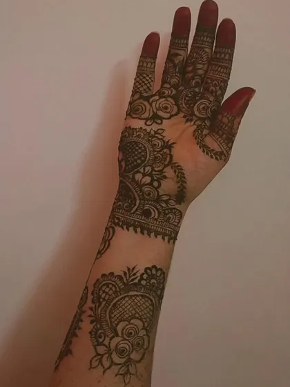 A full view of the arm, showcasing the complete stained bridal design. The color is consistent and deep, a result of my organic henna and proper aftercare.