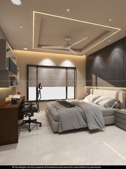 This bedroom includes a dedicated study or work area with a desk and ergonomic chair. The back wall features a dark, textured finish, and the ceiling has modern cove lighting.