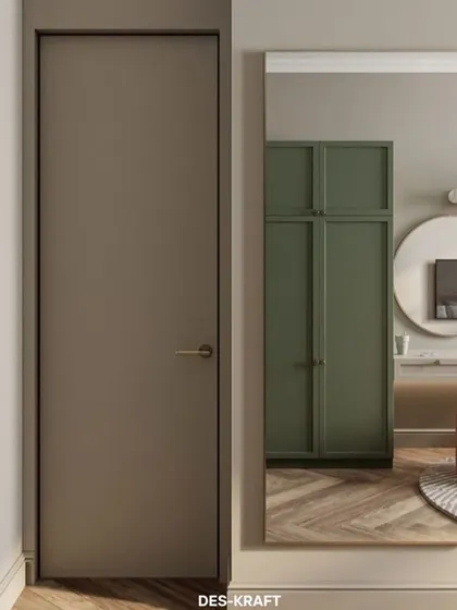 A minimalist door and a large mirror reflect the bedroom's clean lines and green wardrobe, showcasing a cohesive and thoughtfully designed space.
