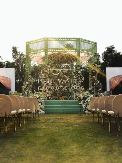 The wedding aisle view, leading towards the elegant gazebo mandap, showing how the design harmonizes with the open lawns of the Golfshire venue.