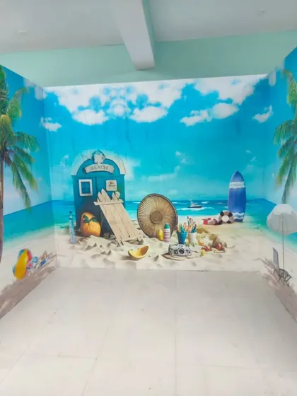 A fun, three-dimensional effect beach scene that wraps around two walls. This type of custom mural is great for creating an immersive and playful environment.