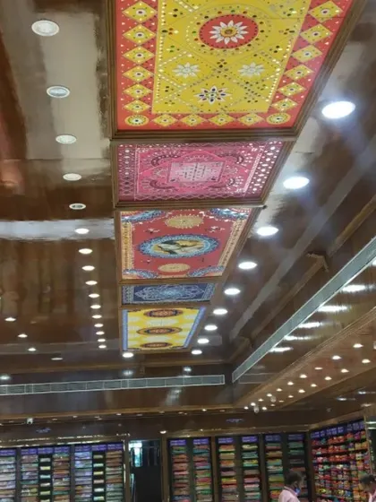 Another view of the installed Lippan art on the showroom ceiling, showing how the different colored panels create a vibrant and continuous design.
