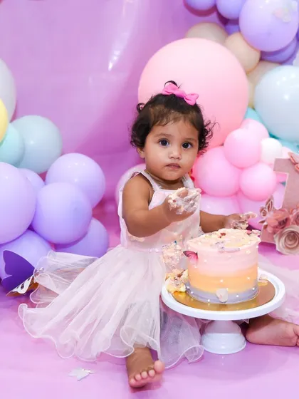 A little bit of cake and a whole lot of cute. This first birthday girl is enjoying every moment of her special cake smash session.