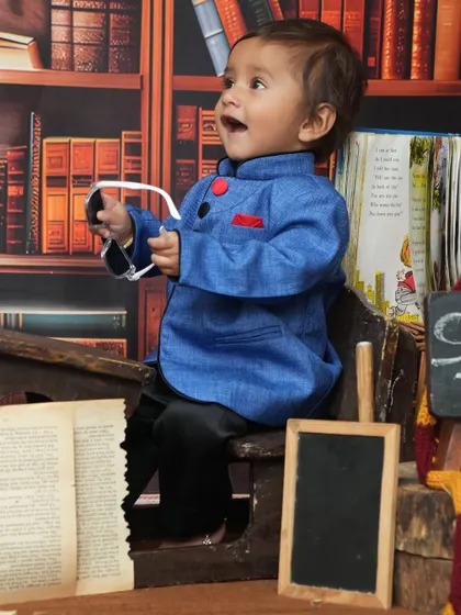 Even little scholars need to be cool. This playful shot with sunglasses adds a fun and modern twist to the vintage 'School Time' theme.