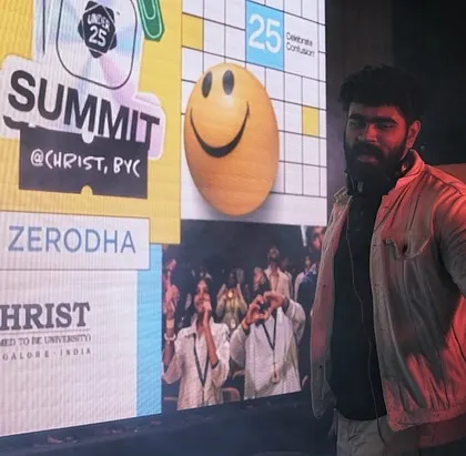 Performing at the Christ University Yeshwanthpur campus for the Under 25 Summit, with the event branding and sponsors like Zerodha displayed on the LED screen.