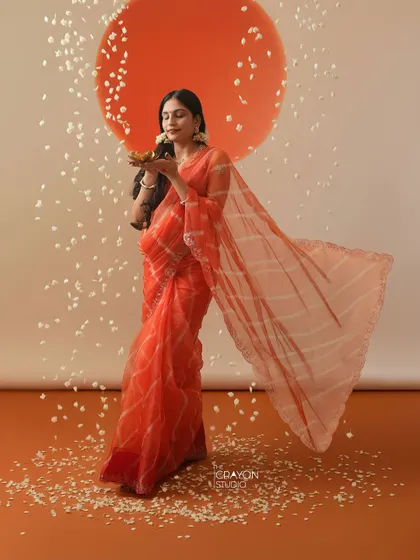 Holding a traditional diya, or lamp, she symbolizes light and hope. This is a powerful and culturally rich pose for a maternity photoshoot.