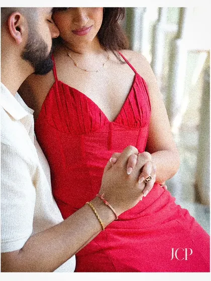 A close-up shot focusing on the couple holding hands, symbolizing their connection.