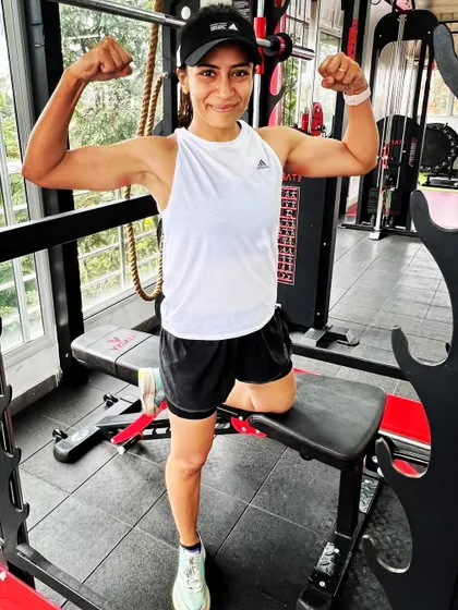 After a long run, it's the strength built in the gym that carries you through. Posing here after a tough session, feeling strong and ready for the miles ahead.