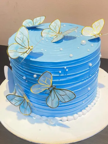 Another angle of the blue butterfly cake, showing the placement of the butterflies to create a sense of movement.