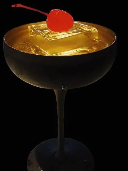 Glamour in a glass. This Cherry Martini, served in a chic matte black coupe with a clear ice cube, is the definition of elegance.