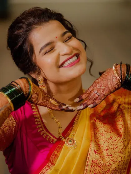 A bride's glow is truly unmatched. This happy, candid shot shows how the right makeup can boost confidence and bring out the brightest smiles.
