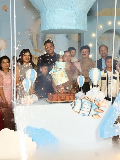 A family celebration for a 4th birthday with a hot air balloon theme, complete with sparklers and a festive atmosphere.