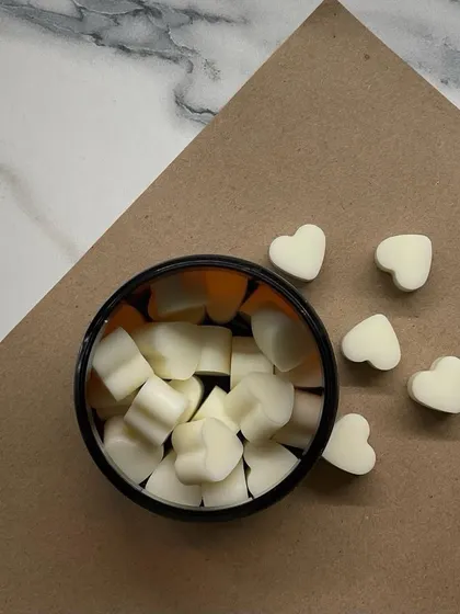 A simple, aesthetic shot of our white heart-shaped wax melts. They are a versatile gift for any occasion.