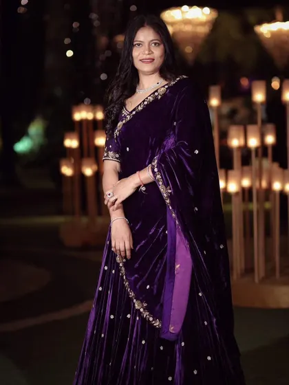 A client looking absolutely regal in a deep purple velvet lehenga. The rich fabric and pearl embroidery make it an ideal choice for a sangeet night or wedding reception.