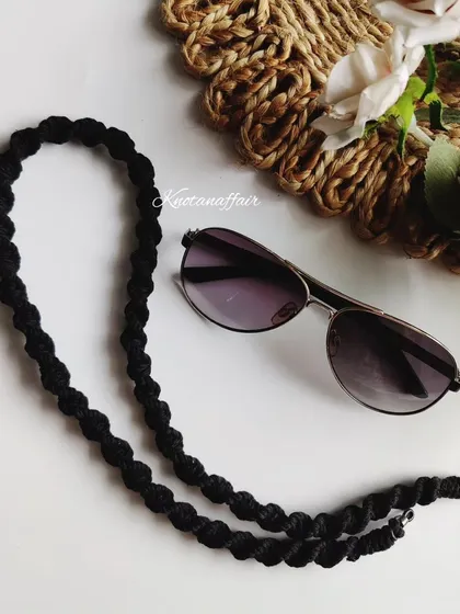 A closer look at the black macrame spectacle chain. It's a great piece of functional jewelry, knotted with soft cotton cord.