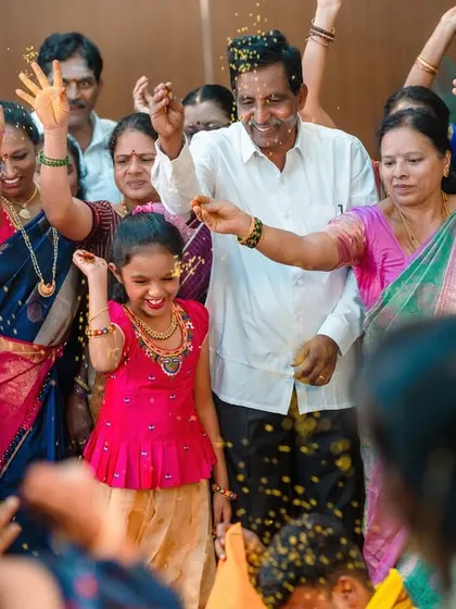 There is so much joy in a family celebration. During this naming ceremony, I focused on capturing candid moments like this, with everyone showering the baby with blessings and flowers. It's these unposed memories that truly tell the story.