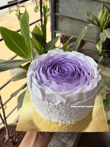 Another view of my signature buttercream flower cake, held up to catch the natural light. The texture and color gradient are what make this design so special.