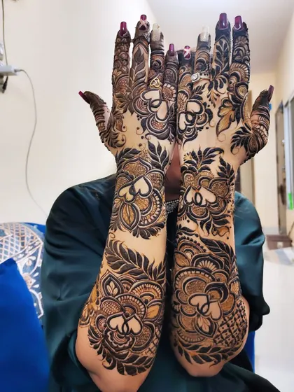 A playful pose showing off a gorgeous full-arm design. The heart motifs woven into the pattern add a touch of romance.