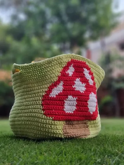 Crochet isn't just for clothes. I made this adorable mushroom-themed basket to hold my yarn and ongoing projects. It’s a fun, functional piece of home decor that adds a touch of handmade charm to my space, crafted with sturdy yarn to hold its shape.