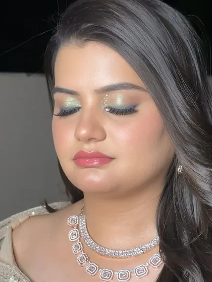 A detailed shot of the eye makeup. The subtle shimmer and perfectly applied lashes create a look that is captivating and glamorous.