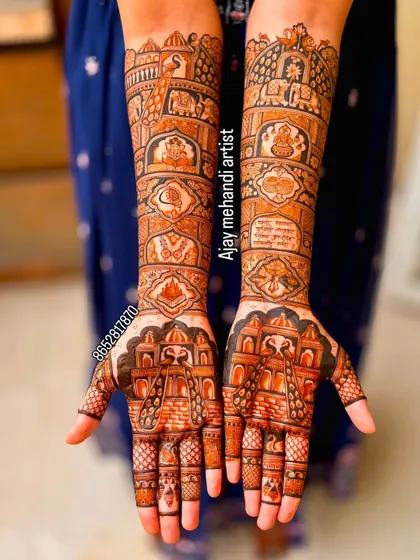 This full-coverage bridal mehndi includes various traditional elements like palace architecture, elephants, and auspicious symbols, telling a complete story on the bride's hands.