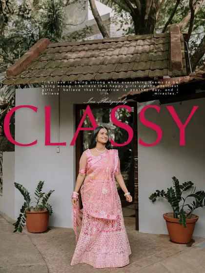 A full-length shot from the same "classy" series, showcasing the intricate pink lehenga against the backdrop of a traditional home.