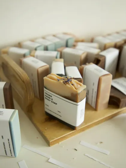 An assortment of soaps on a wooden tray, waiting to be packaged.