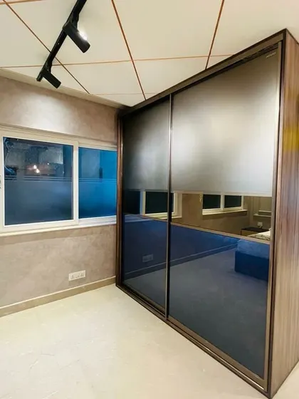 A sliding wardrobe with tinted mirror panels on display at my experience center. This type of wardrobe adds depth and a modern feel to any bedroom.