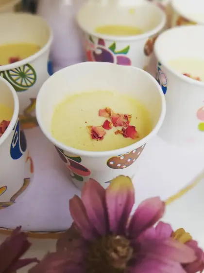 A close-up of our refreshing thandai, garnished with delicate rose petals. It's these small details that elevate the food experience at our catered events.