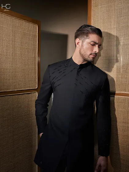 A closer look at the embroidered Achkan, showing how the subtle detailing catches the light. It's a piece for the man who appreciates quiet confidence and masterful craftsmanship.