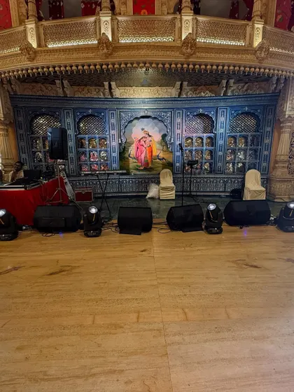 A closer look at the stage setup for a 60th birthday celebration. I position professional sound monitors and moving head lights to ensure perfect audio and lighting coverage for the live band and performances.
