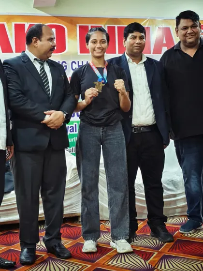 Another champion from our team, proudly showing her medal at a national competition.