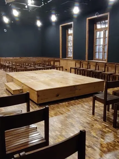 The completed Black Box Theatre, transformed from a design lab into a flexible performance space with a modular stage, professional lighting, and acoustic treatment.