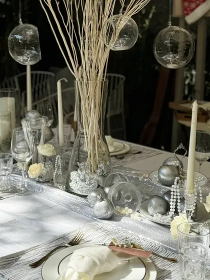 Another view of the luxe silver and white tablescape, showcasing the layers of texture and shimmer that create a truly magical and sophisticated dining experience.