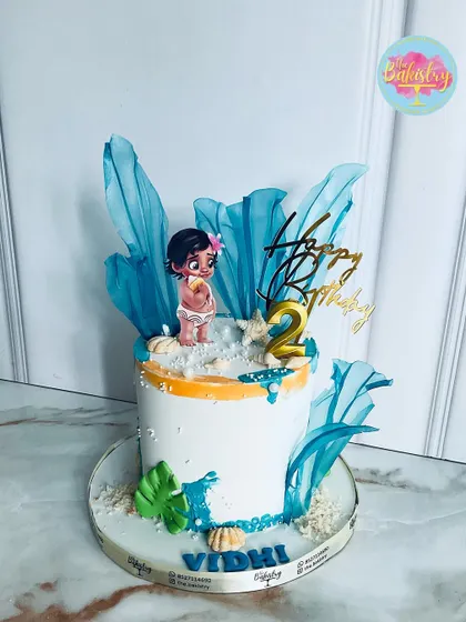 A beautiful Moana-themed cake for Vidhi's 2nd birthday, with ocean waves and a baby Moana topper.