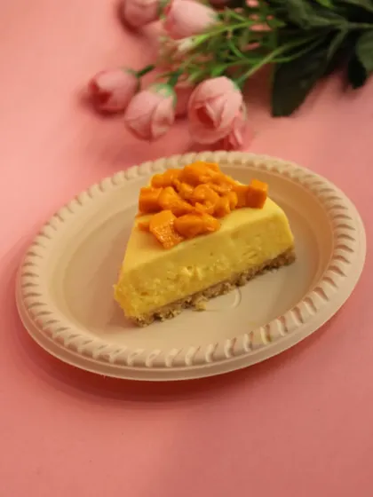 When mangoes are in season, our Mango Cheesecake is a must-try. This slice showcases a creamy cheesecake base topped with fresh, sweet mango chunks.