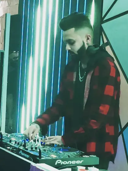 Don't wait for opportunity, create it. A focused shot of me mixing at Badmaash Lounge, under the watchful eye of the tiger mural.