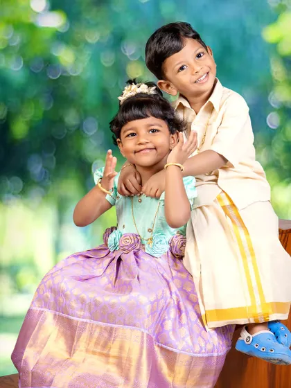 The bond between siblings is a treasure. I love creating portraits like this that capture the playful and loving connection between a brother and sister, dressed in beautiful traditional attire for a timeless look.