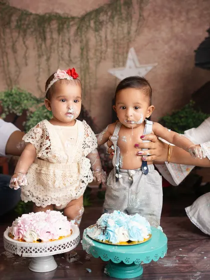 Double the trouble, double the fun. A half birthday cake smash for twins is twice as messy and twice as cute.