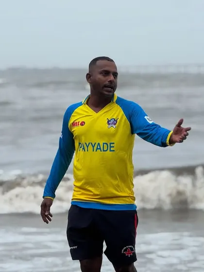 A coach directs players during a demanding beach training session, ensuring every drill is performed with maximum effort and correct technique.