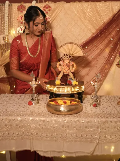 A candid moment from my Ganesh Chaturthi celebration, featuring a traditional red saree and simple, elegant makeup.