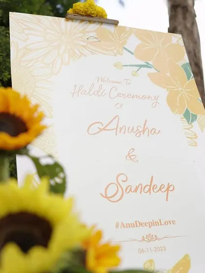 A welcome sign for a Haldi ceremony, perfectly themed with sunflowers and a sunny yellow color palette.