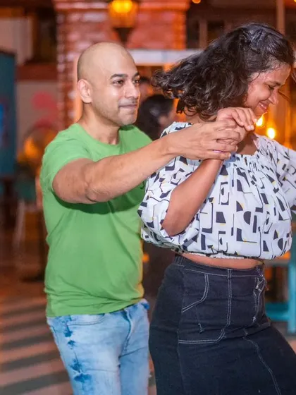 A dynamic hair flip during a fast-paced Salsa turn. The energy on our dance floor is absolutely contagious.